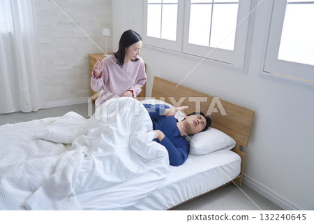 A wife waking up her husband in the morning 132240645