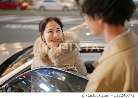 Men and women standing in the city at night 132240771