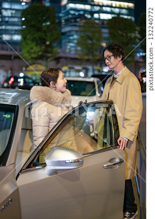 Men and women standing in the city at night 132240772