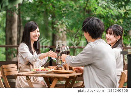 Young Asian men and women, friends, companions, colleagues having a barbecue, home party, glamping on a wooden deck 132240806