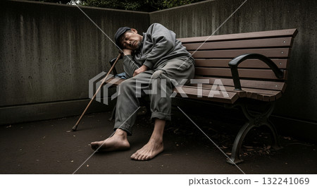 Homeless man sleeping on a bench in the corner of the park Homeless man sleeping on a bench in the corner of the park 132241069