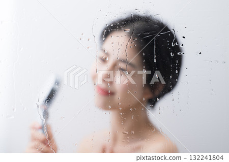 一位女士在淋浴中洗身體，水滴美麗，沒有臉 132241804