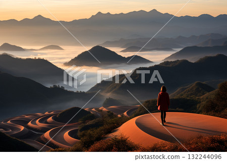 Solitary Wanderer Overlooking Misty Mountain Roads 132244096