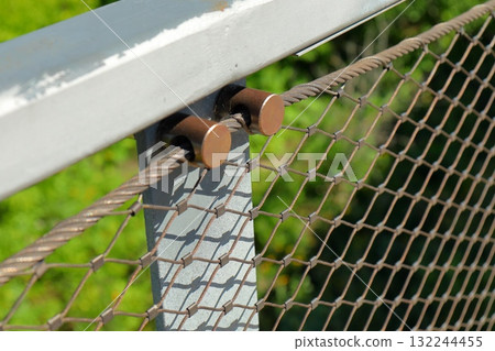 Metal wire fence detail on bridge 132244455