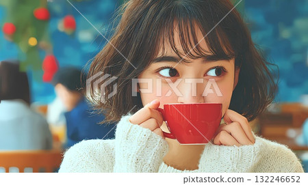 A woman drinking hot drinks 132246652
