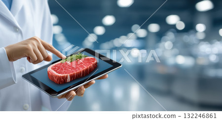 Food tech concept showing raw steak on tablet screen with herb garnish evoking innovation Food tech concept showing raw steak on tablet screen with herb garnish evoking innovation 132246861
