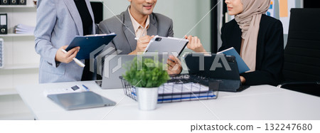 Group of young Asian business people discussing business plan at modern startup in creative business discussing work Group of young Asian business people discussing business plan at modern startup in creative business discussing work 132247680