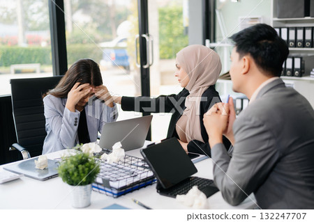 Furious Asian businesspeople arguing strongly after making a mistake at work in office Furious Asian businesspeople arguing strongly after making a mistake at work in office 132247707