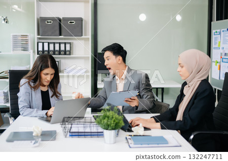 Furious Asian businesspeople arguing strongly after making a mistake at work in office Furious Asian businesspeople arguing strongly after making a mistake at work in office 132247711