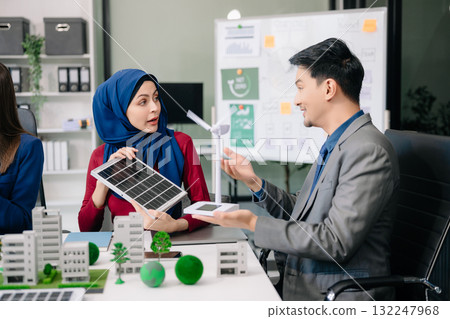 business team people planning and discussing on recycle reduce reuse policy symbol in office meeting room. Green business company and Solar Energy Environment city business team people planning and discussing on recycle reduce reuse policy symbol in office meeting room. Green business company and Solar Energy Environment city 132247968