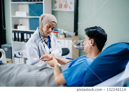 Muslim female doctors providing medical care in a modern clinic, with a focus on healthcare, patient treatment Muslim female doctors providing medical care in a modern clinic, with a focus on healthcare, patient treatment 132248114