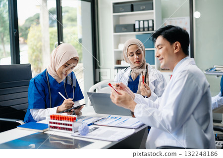 Medical professionals in modern hospital collaborating on patient care, research, and diagnosis. Doctors and nurses in hijabs discussing treatment plans, lab Medical professionals in modern hospital collaborating on patient care, research, and diagnosis. Doctors and nurses in hijabs discussing treatment plans, lab 132248186