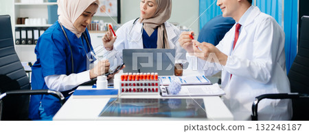 Medical professionals in modern hospital collaborating on patient care, research, and diagnosis. Doctors and nurses in hijabs discussing treatment plans, lab Medical professionals in modern hospital collaborating on patient care, research, and diagnosis. Doctors and nurses in hijabs discussing treatment plans, lab 132248187
