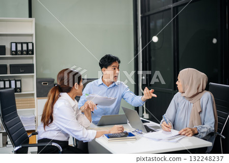 Furious team Asian businesspeople arguing strongly after making a mistake at work in office Furious team Asian businesspeople arguing strongly after making a mistake at work in office 132248237