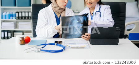 Medical professionals in modern clinic, discussing treatment and prescriptions. Healthcare, teamwork, consultation, diagnosis, and therapy Medical professionals in modern clinic, discussing treatment and prescriptions. Healthcare, teamwork, consultation, diagnosis, and therapy 132248300