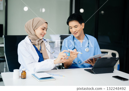 Doctor Talks With Professional Head Nurse or Surgeon, They Use Digital tablet Computer. Diverse Team of Health Care Specialists Doctor Talks With Professional Head Nurse or Surgeon, They Use Digital tablet Computer. Diverse Team of Health Care Specialists 132248492
