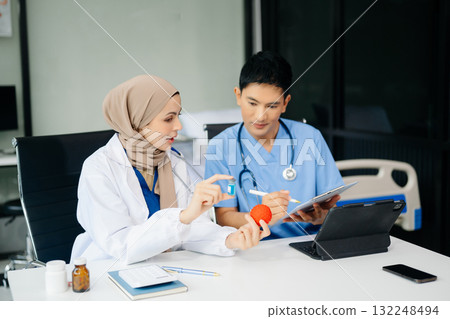 Doctor Talks With Professional Head Nurse or Surgeon, They Use Digital tablet Computer. Diverse Team of Health Care Specialists Doctor Talks With Professional Head Nurse or Surgeon, They Use Digital tablet Computer. Diverse Team of Health Care Specialists 132248494