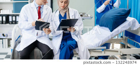 Medical professionals in modern hospital collaborating on patient care, research, and diagnosis. Doctors and nurses in hijabs discussing treatment plans, lab Medical professionals in modern hospital collaborating on patient care, research, and diagnosis. Doctors and nurses in hijabs discussing treatment plans, lab 132248974