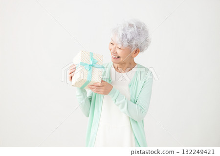Senior woman happy with present Senior woman happy with present 132249421