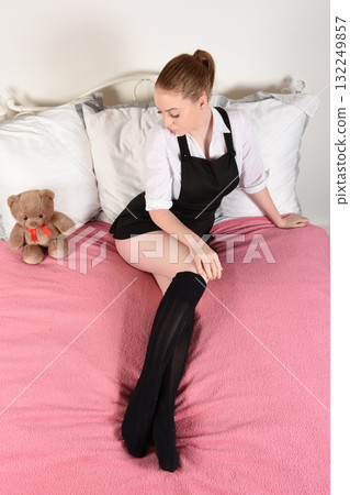 Attractive redhead model dressed as a fantasy St Trinians schoolgirl Attractive redhead model dressed as a fantasy St Trinians schoolgirl 132249857