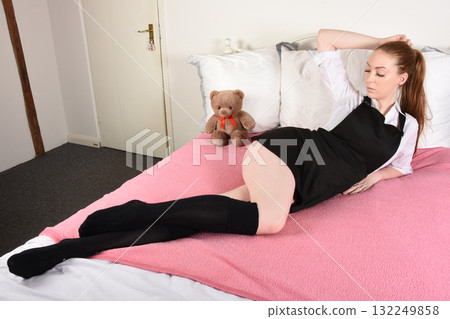 Attractive redhead model dressed as a fantasy St Trinians schoolgirl 132249858