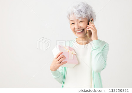 Senior woman happy to receive a smartphone gift Senior woman happy to receive a smartphone gift 132250831
