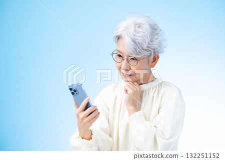 Senior female looking at a smartphone Senior female looking at a smartphone 132251152