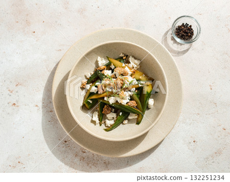 Asian Quick Pickled Cucumbers in Salad. Delicious salad with Asian style pickles cucumbers, goat cheese and walnuts nuts. Ideas and recipes for healthy breakfast, lunch or dinner. Top view or flat lay Asian Quick Pickled Cucumbers in Salad. Delicious salad with Asian style pickles cucumbers, goat cheese and walnuts nuts. Ideas and recipes for healthy breakfast, lunch or dinner. Top view or flat lay 132251234