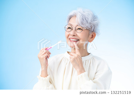 Oral care: Middle-aged woman brushing her teeth Oral care: Middle-aged woman brushing her teeth 132251519