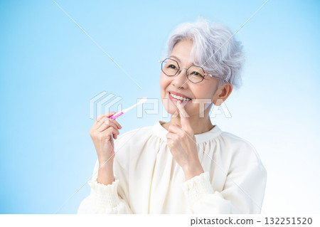 Oral care: Middle-aged woman brushing her teeth Oral care: Middle-aged woman brushing her teeth 132251520