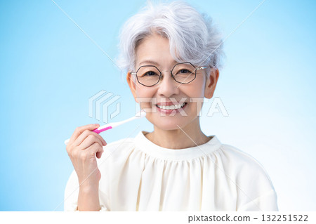 Oral care: Middle-aged woman brushing her teeth Oral care: Middle-aged woman brushing her teeth 132251522