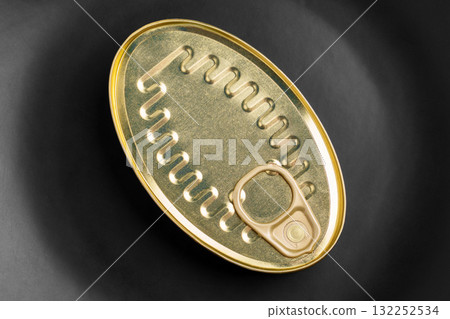 Metal can of canned tuna fish on black ceramic close up. Top view Metal can of canned tuna fish on black ceramic close up. Top view 132252534
