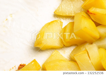 Fried potato slices in a glass container close up 132252536