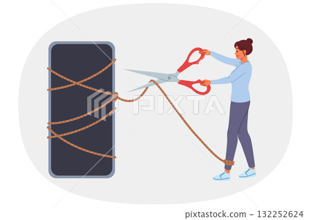Digital detox is done by woman with mobile phone, cutting rope with scissors to get rid of addiction 132252624