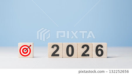 Setting business goals for new year 2026. Wooden blocks with number and target icon on white and blue background Setting business goals for new year 2026. Wooden blocks with number and target icon on white and blue background 132252656