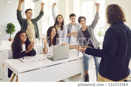 Cheerful multiracial students having fun celebrating success during teamwork in lecture. Cheerful multiracial students having fun celebrating success during teamwork in lecture. 132253364