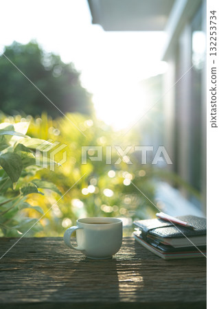 Brown coffee and leather notebooks on brown wooden table 132253734