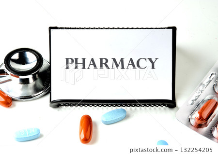 Capsules of various colors lie scattered next to a stethoscope and a pharmacy sign, creating a vivid display of healthcare essentials in a clean, bright workspace Capsules of various colors lie scattered next to a stethoscope and a pharmacy sign, creating a vivid display of healthcare essentials in a clean, bright workspace 132254205