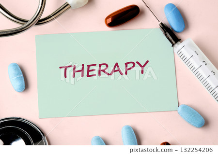 A therapy card prominently displays the word THERAPY, surrounded by medication, a syringe, and medical equipment, illustrating the importance of treatment in health and wellness A therapy card prominently displays the word THERAPY, surrounded by medication, a syringe, and medical equipment, illustrating the importance of treatment in health and wellness 132254206