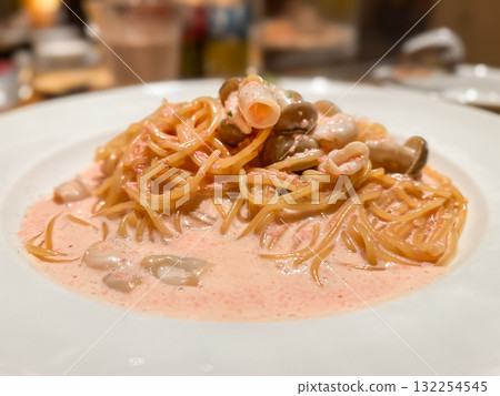 Mentaiko cream pasta. Spaghetti with mushrooms and squid. 132254545