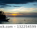 Sunset with pirogue at Lia Beach, Waleakodi Island, Togian archipelago, Indonesia 132254599