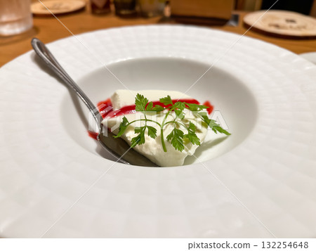 Panna cotta topped with berry sauce, a sweet milk-flavored dessert. 132254648