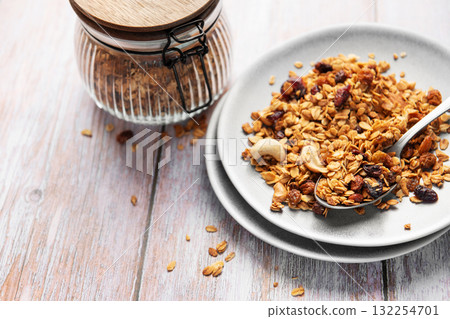 Healthy homemade granola mix on plate with spoon 132254701