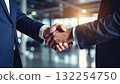Businessmen handshake agreement inside modern office environment 132254750