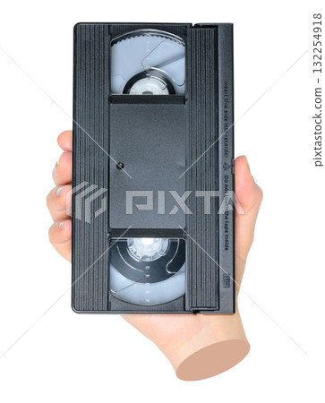 Woman hand holds a retro old analog video cassette, isolated on transparent background, retro things concept. Contemporary art Woman hand holds a retro old analog video cassette, isolated on transparent background, retro things concept. Contemporary art 132254918