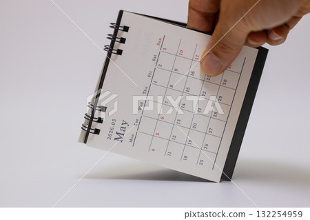Stock photo of May 2026 desk calendar held in hand Stock photo of May 2026 desk calendar held in hand 132254959