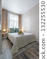 Bright Cozy Bedroom with Soft Lighting and Fresh Towels 132255530
