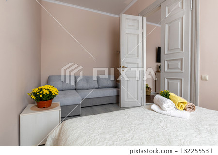 Cozy Apartment Bedroom with Sofa and Fresh Towels 132255531
