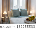 Modern Cozy Bedroom with Soft Lighting and Fresh Towels 132255533