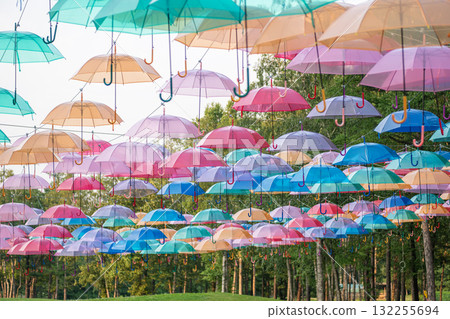 Colorful umbrellas hanging outdoors in park decorative installation at Shinfurano Prince Hotel Picnic Garden ,Furano, Hokkaido, Japan 132255694